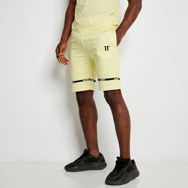 Men's pastel - colored cotton shorts for a spring - friendly outfit   Cut & Sew Taped Sweat Shorts - Yellow Sherbet
