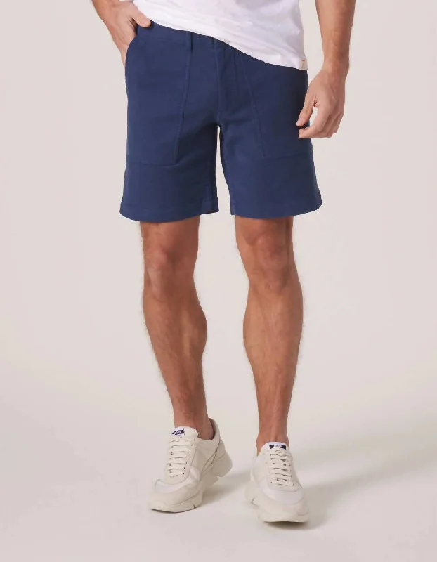 Men's ripped denim shorts for a trendy streetwear aesthetic Tailored Terry Utility Short In Dark Blue Men's ripped denim shorts for a trendy streetwear aesthetic Tailored Terry Utility Short In Dark Blue